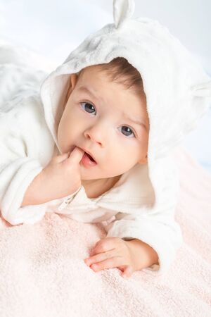 the beautiful little baby, lie  on stomach  on towelの写真素材