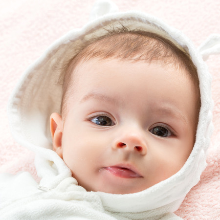 the beautiful little baby, lie  on stomach  on towelの写真素材
