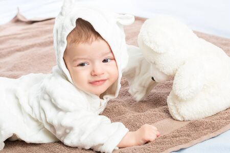 the beautiful little baby, lie  on stomach  on towelの写真素材