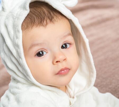 the beautiful little baby, lie  on stomach  on towelの写真素材