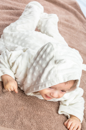 the beautiful little baby, lie  on stomach  on towelの写真素材