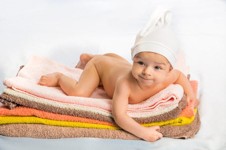 the beautiful baby on colorful towels stackの写真素材