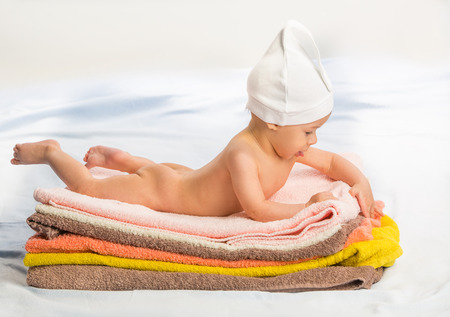 the beautiful baby on colorful towels stackの写真素材