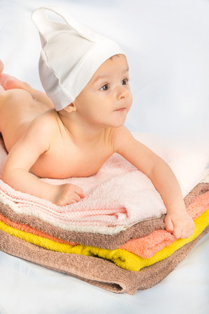 the beautiful baby on colorful towels stackの写真素材