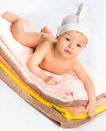 the beautiful baby on colorful towels stackの写真素材