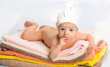 the beautiful baby on colorful towels stackの写真素材