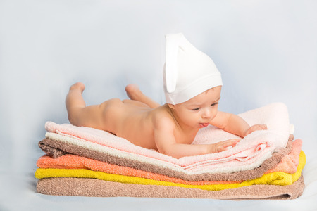the beautiful baby on colorful towels stackの写真素材
