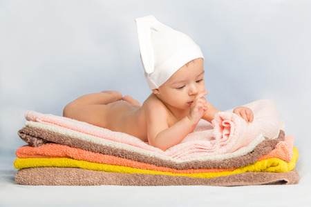 the beautiful baby on colorful towels stackの写真素材