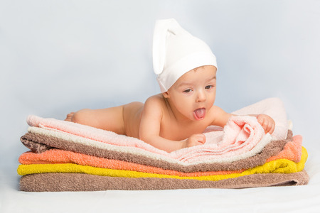 the beautiful baby on colorful towels stackの写真素材