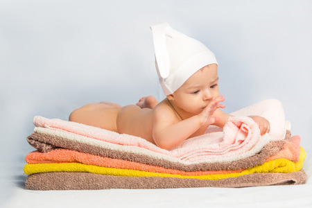the beautiful baby on colorful towels stackの写真素材