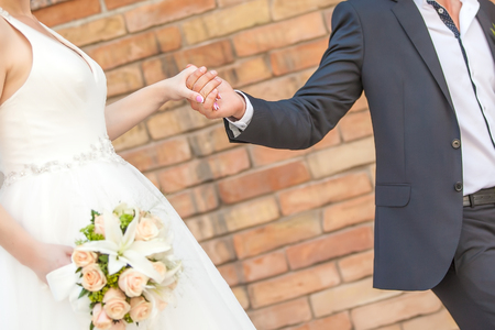 Wedding couple holding hands. bride and groomの写真素材