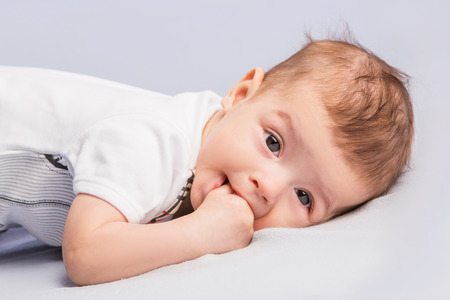 portrait of the beautiful little baby, lie  on stomach