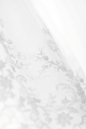White Wedding dress hanging on a shoulders. Soft light and coloursの写真素材