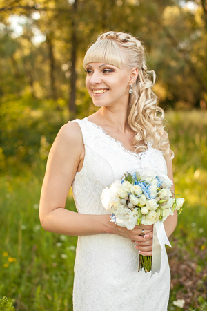 the young beautiful bride on the natureの写真素材
