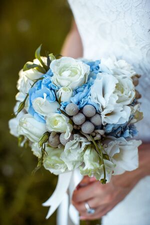 The bride holds the beautiful wedding bouquetの写真素材