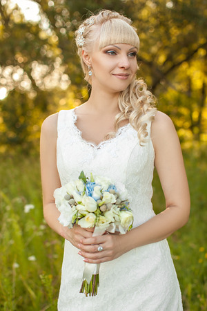the young beautiful bride on the natureの写真素材