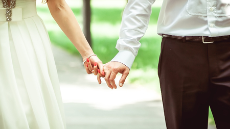 Wedding couple holding hands. bride and groomの写真素材