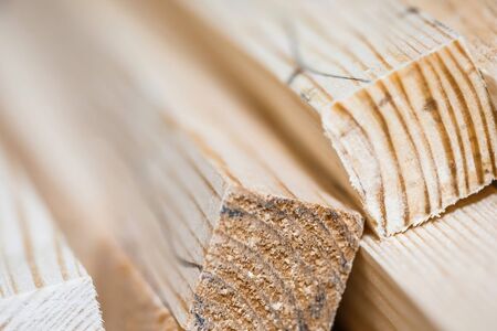 Wooden beams and planks. Lumber stacked at construction siteの写真素材