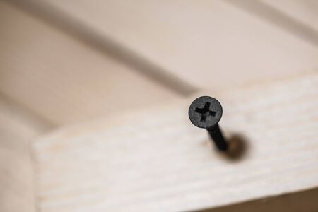 the screws wrapped in the wooden boardの写真素材