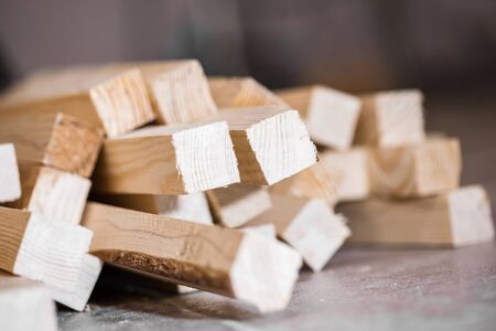 Wooden beams and planks. Lumber stacked at construction siteの写真素材