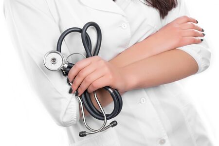 Closeup portrait of a female doctor holding her stethoscope on white backgroundの写真素材