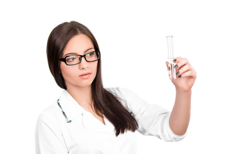 A female medical or woman doctor looking at a clear solution. Scientific researcher hands a vial, isolated on whiteの写真素材