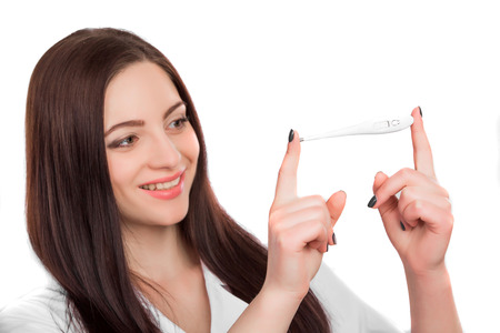 Smiling young female doctor holding thermometer  on white background