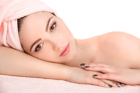 Young beautiful  attractive woman receiving facial massage and spa treatment over white background. Perfect Skin. Skincare. Young Skinの写真素材