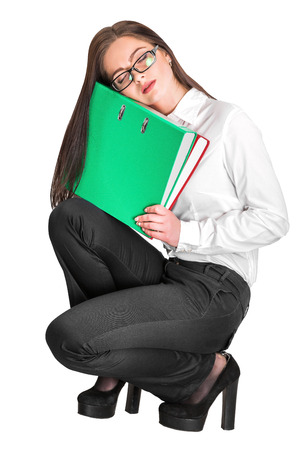 Portrait of attractive businesswoman in glasses holding red and green folders isolated on white backgroundの写真素材