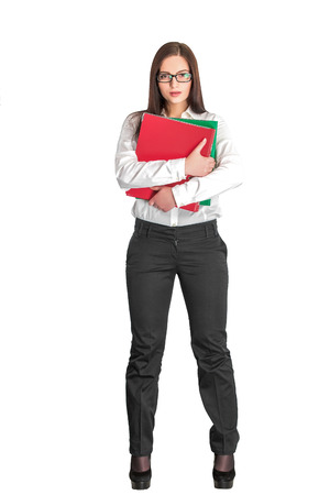 attractive businesswoman in glasses holding red and green folders isolated on white backgroundの写真素材