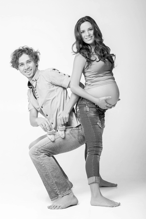 beautiful pregnant woman with her husband. future mother and father in t-shirt and jeans. black and whiteの写真素材