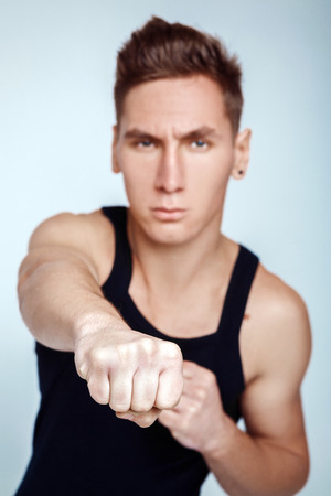 White male clenched fist, punching up into the air.の写真素材