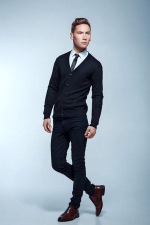 Handsome businessman posing on light background. young attractive and confident manの写真素材