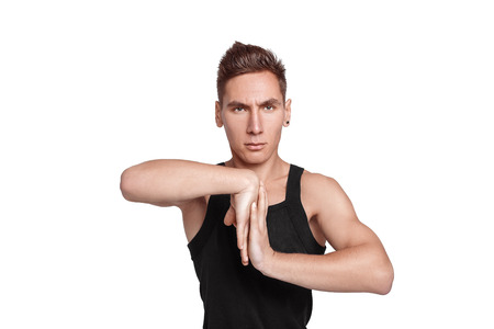 attractive young man doing exercises on white backgroundの写真素材