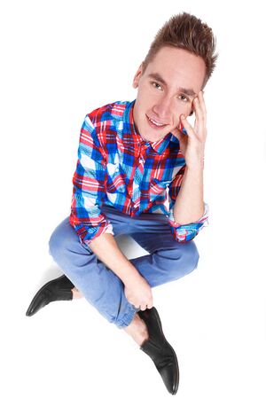 attractive young cheerful man in checked shirt on white backgroundの写真素材