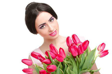 Portrait of beautiful smiling  dark-haired woman with  tulip bouquet. Spring portrait.の写真素材