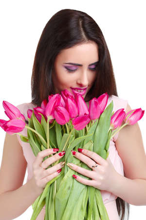 Portrait of beautiful smiling  dark-haired woman with  tulip bouquet. Spring portrait.の写真素材