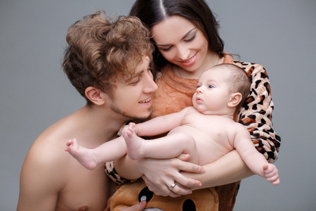 mom dad and baby. Loving parents with their cute little sonの写真素材