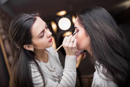 Makeup artist apply makeup to a model.の写真素材