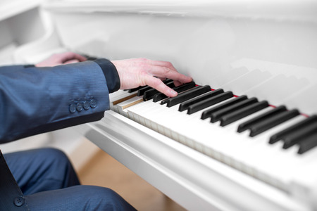 Close up of man hands playing pianoの写真素材