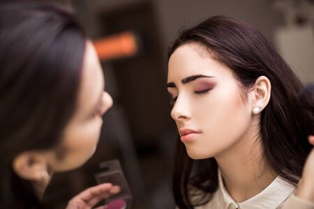 Makeup artist apply makeup to a model.の写真素材