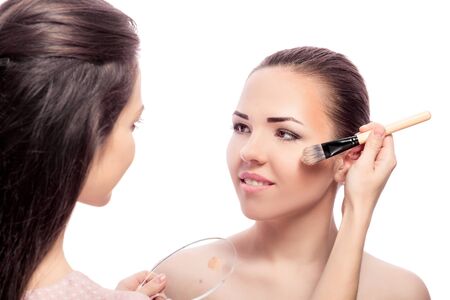 the makeup artist applied with a Foundation brush on the face. perfect skin women. makeup for brunettesの写真素材