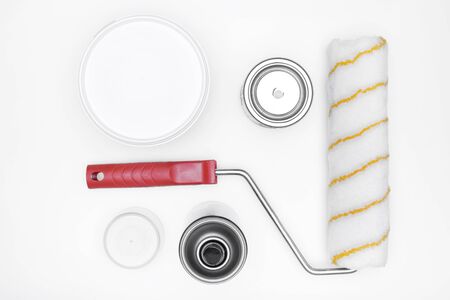 the tools of a painter: paint,  paint-roller on white background, top viewの写真素材