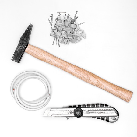 hammer, knife , wire and nails on white backgroundの写真素材