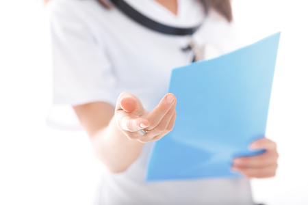 A doctor holding blue folder. female hand close-upの写真素材