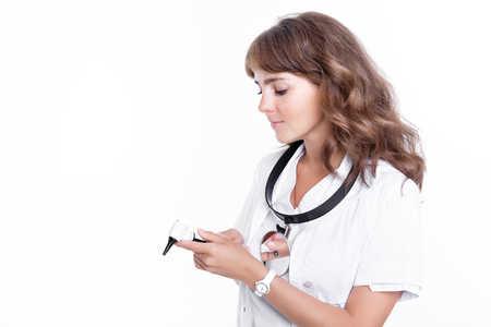 Doctor ENT is holding the Otoscope. Otolaryngologist in white coat