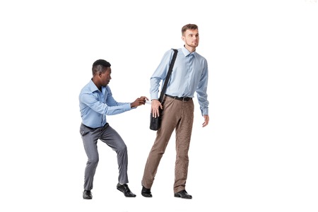 one businessman stole from other documents from the bag isolated on a white backgroundの写真素材