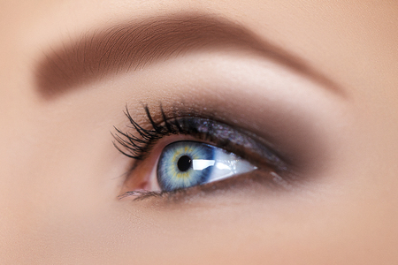 blue woman eye with beautiful brown shadesの写真素材