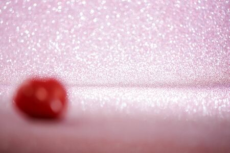 background with blurred red heart in the foreground .の写真素材