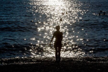 blurred background Silhouette of woman  on sea coastの写真素材